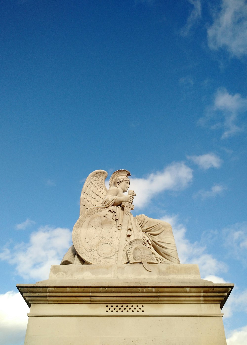 a statue of an angel on top of a building