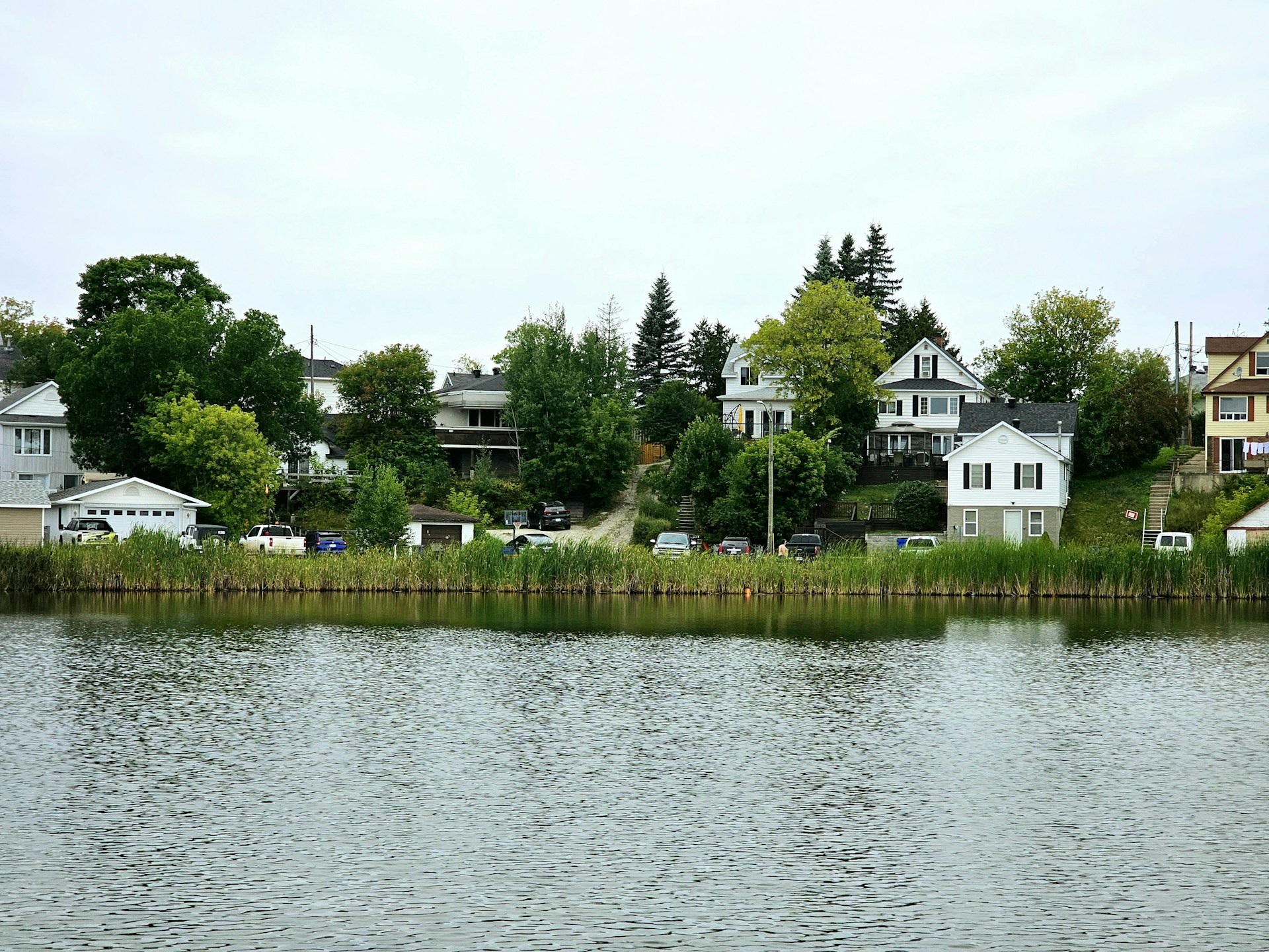 a body of water with houses in the background