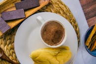 Children and adults sharing chocolate tasting and stories in a cozy village setting.