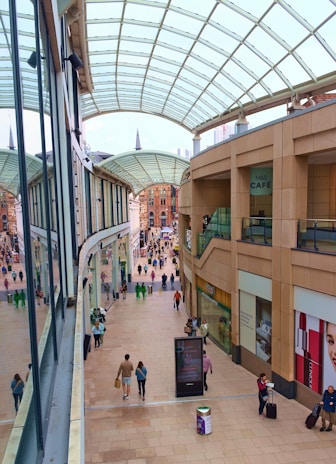 a group of people walking around a shopping mall