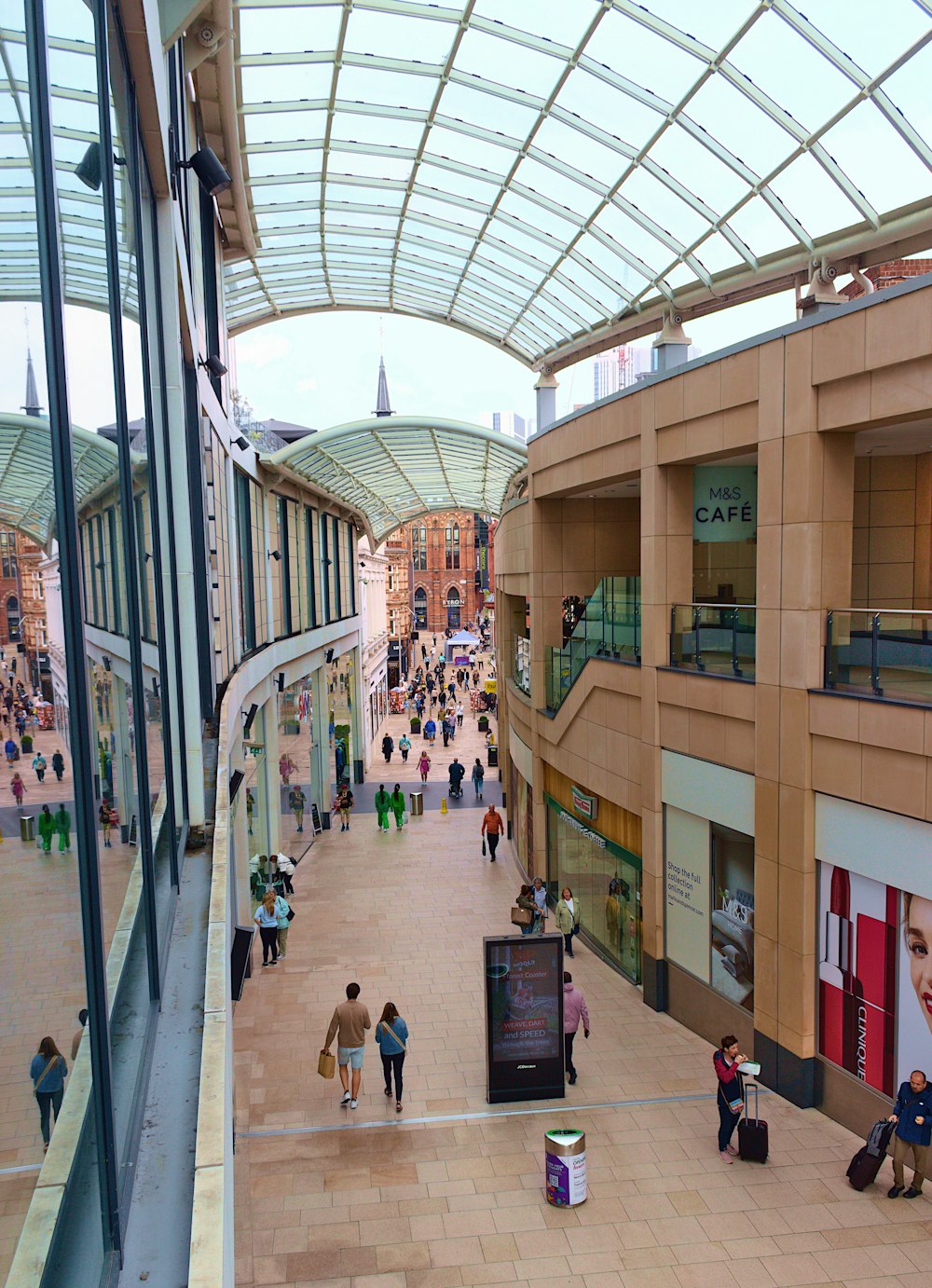 a group of people walking around a shopping mall