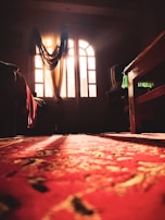 A soft, neutral-toned rug laid out in a sunlit bedroom, highlighting subtle patterns.