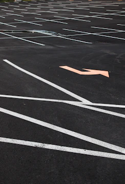 A newly striped commercial parking lot with clear markings and smooth asphalt surface.
