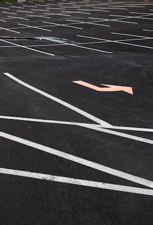 A freshly painted parking lot with crisp white and yellow lines under a clear blue sky.