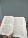 Close-up image of a student studying Sanskrit from a textbook in a classroom setting.