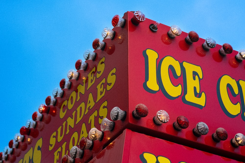 a close up of a large red ice cream sign