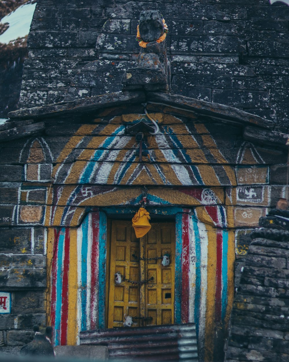 a building with a yellow door and a striped door