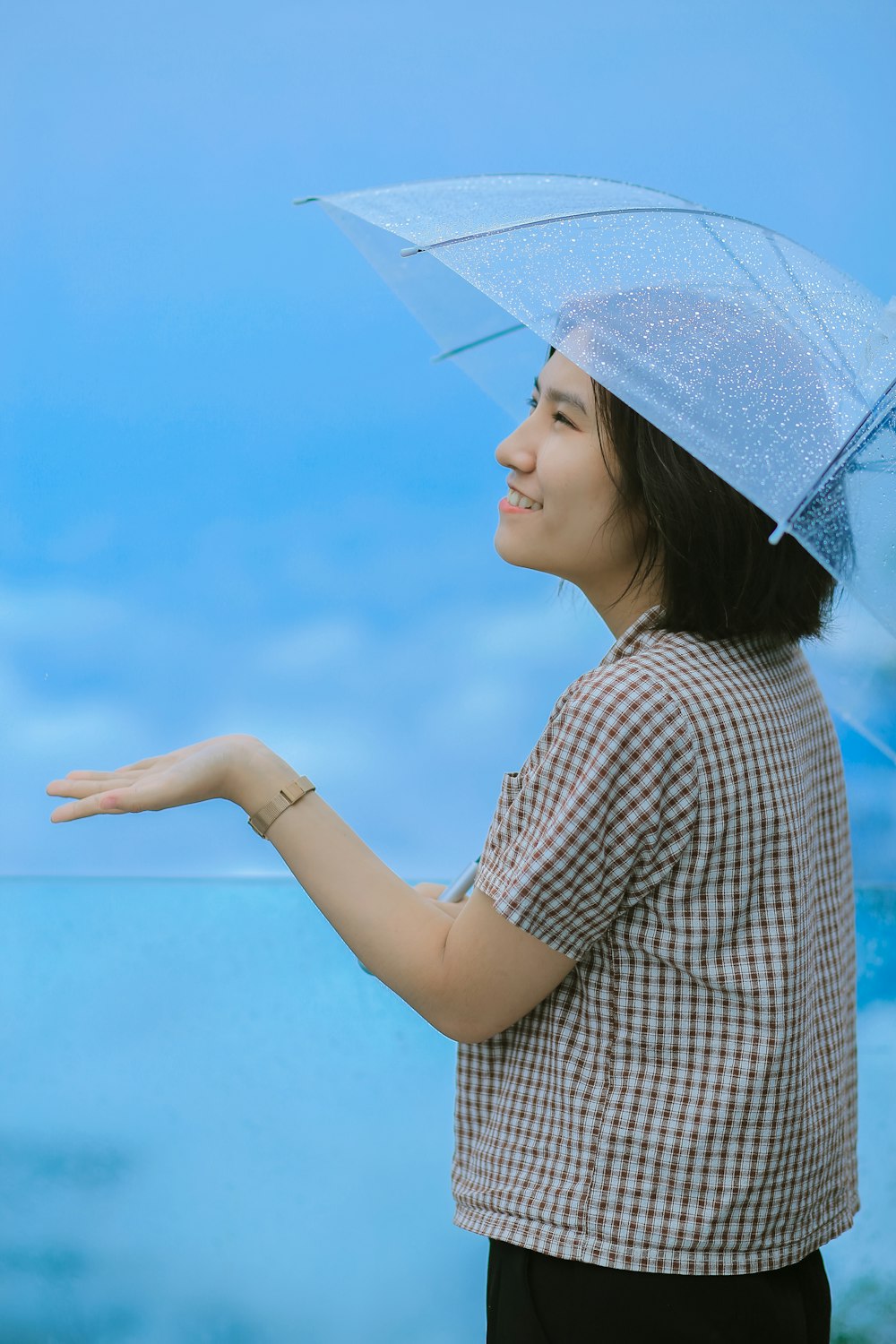 a woman holding an umbrella over her head