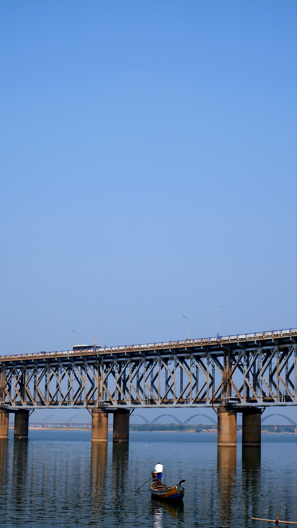 a train crossing a bridge over a body of water