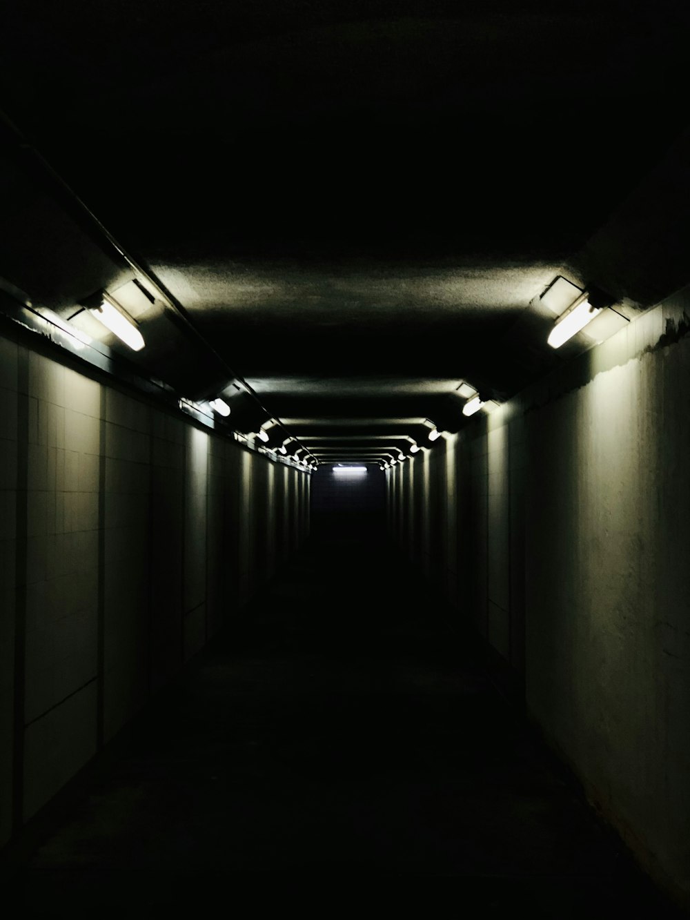 a long dark tunnel with light at the end