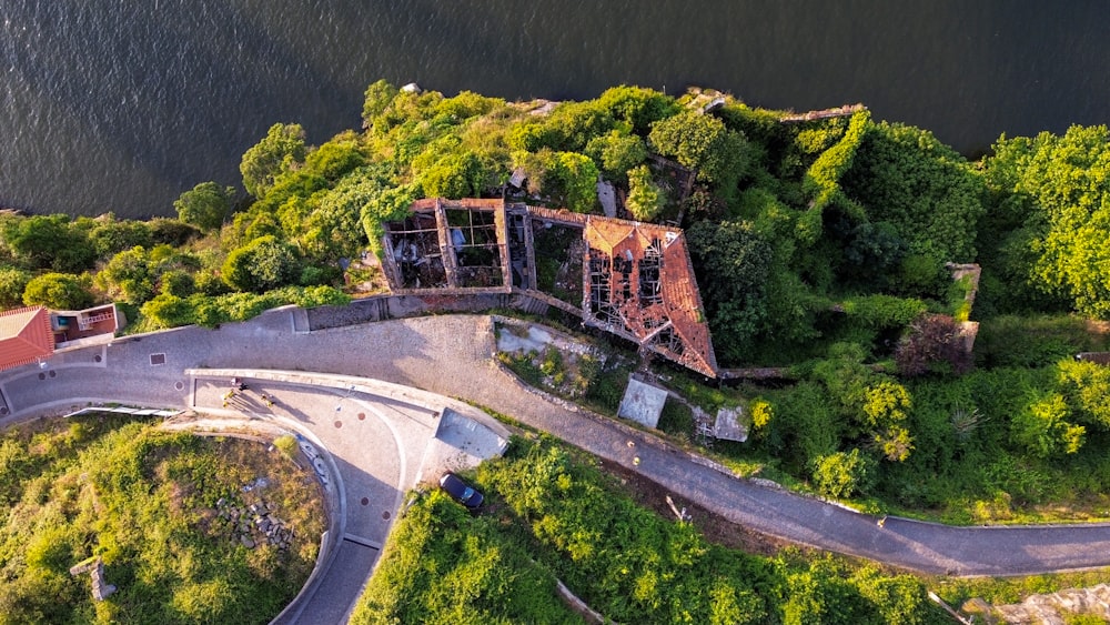 an aerial view of an old building in the middle of a forest