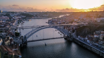 a bridge over a river with a city in the background