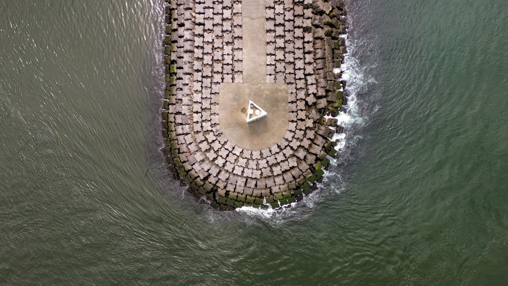 an aerial view of a pier in the water