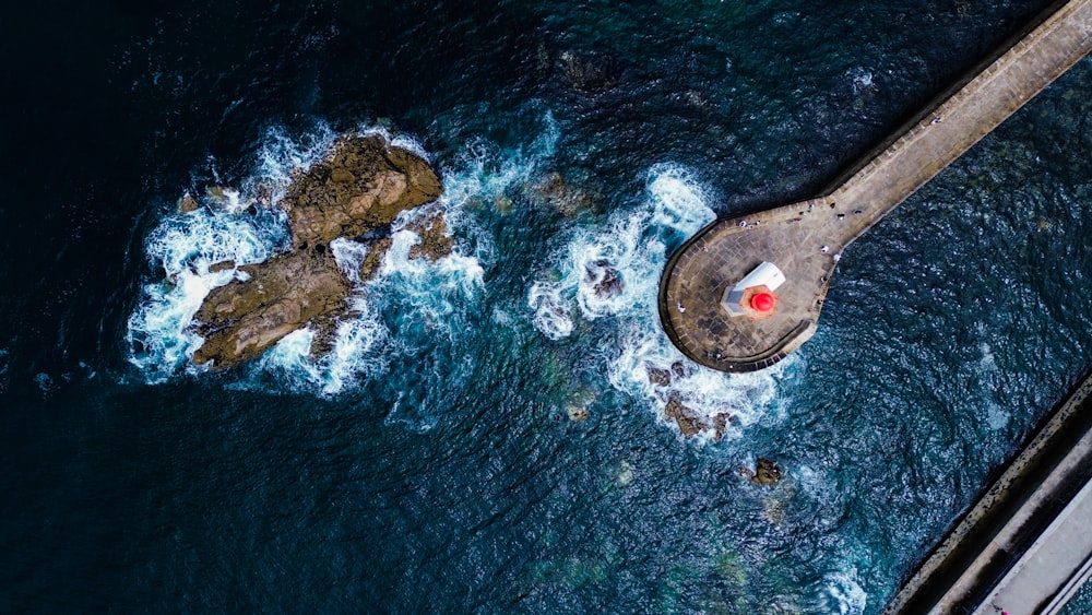 an aerial view of the ocean with a red light on it