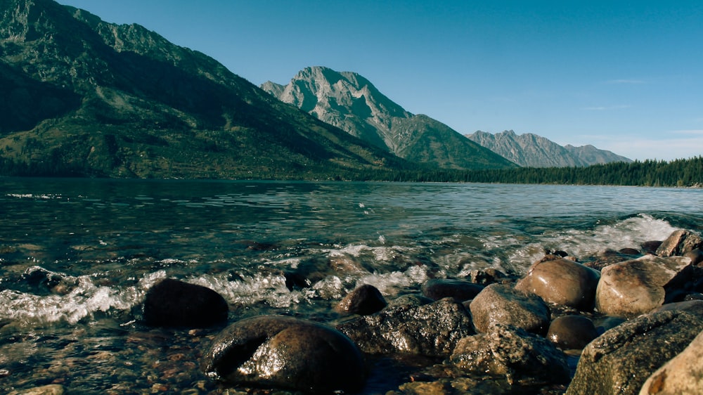 a body of water surrounded by mountains and rocks