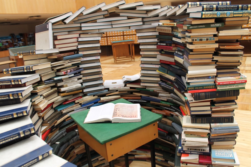 a room filled with lots of books on top of a wooden floor