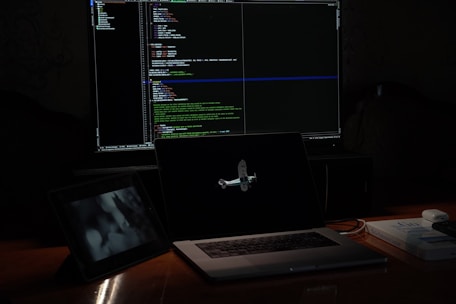a laptop computer sitting on top of a wooden desk