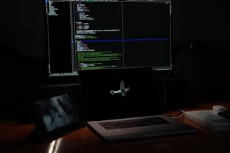 a laptop computer sitting on top of a wooden desk
