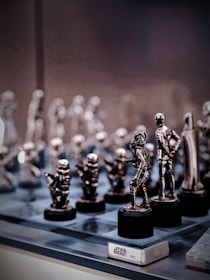 Close-up of detailed gaming figure replicas displayed on a shelf with vibrant lighting.