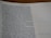 A close-up view of a page from a Bible open to the book of Ezekiel, with text visible and partially focused on verses discussing divine warnings and moral guidance. The page appears to be on a desk, and part of the page is slightly out of focus.