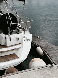a sailboat docked at a dock in the water