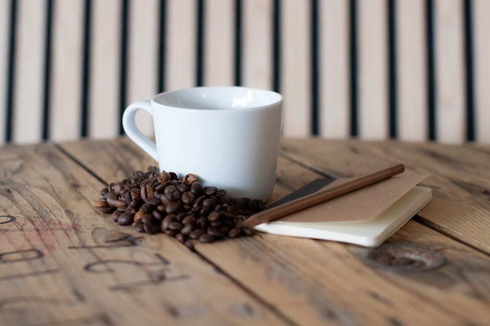 a cup of coffee sitting on top of a wooden table