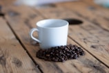 a cup of coffee sitting on top of a wooden table