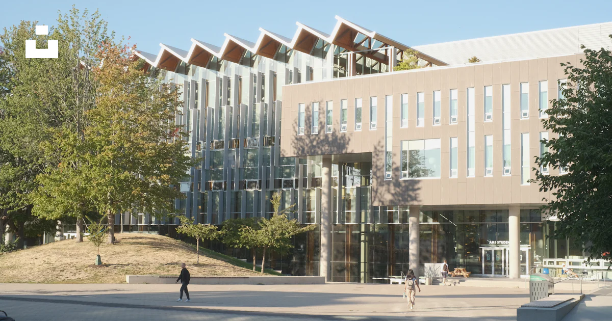 A person walking in front of a building photo – Free Ubc alumni centre ...