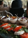 a wooden table topped with bowls of food