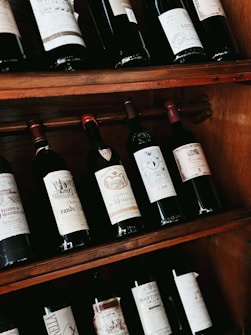a shelf filled with lots of bottles of wine