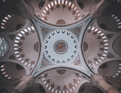 A serene mosque interior with soft natural light highlighting elegant Islamic geometric patterns.