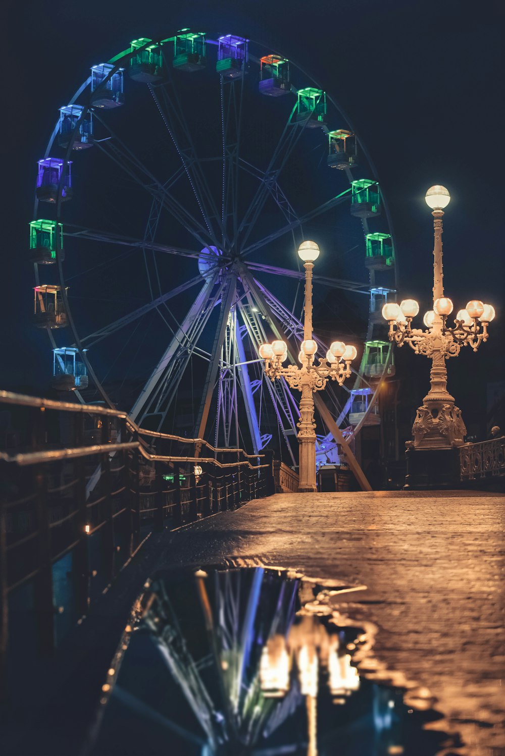 a ferris wheel is lit up at night