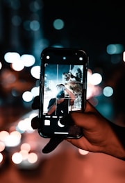 A user taking a photo with a smartphone.
