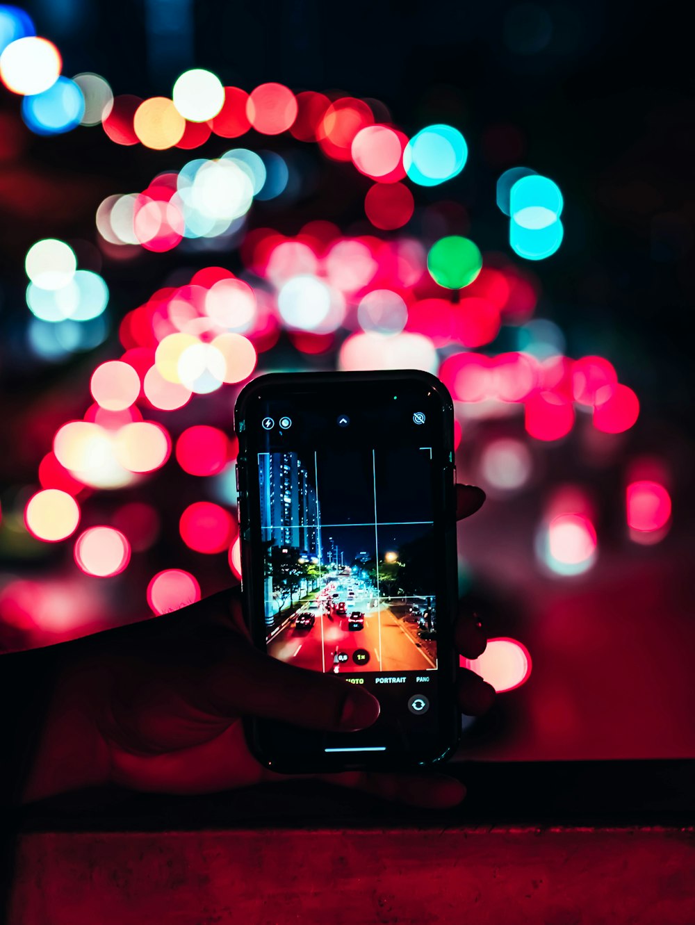 a person taking a picture of a street with a cell phone