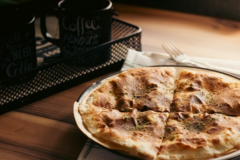 a pizza sitting on top of a plate on a table