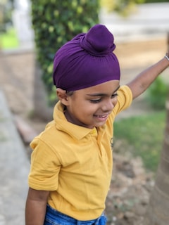 Parminder engaging with children during a local outreach event, sharing smiles and stories.