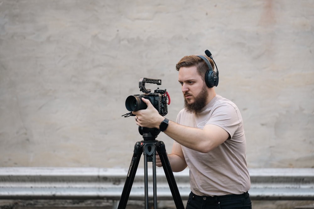 a man with headphones and a camera