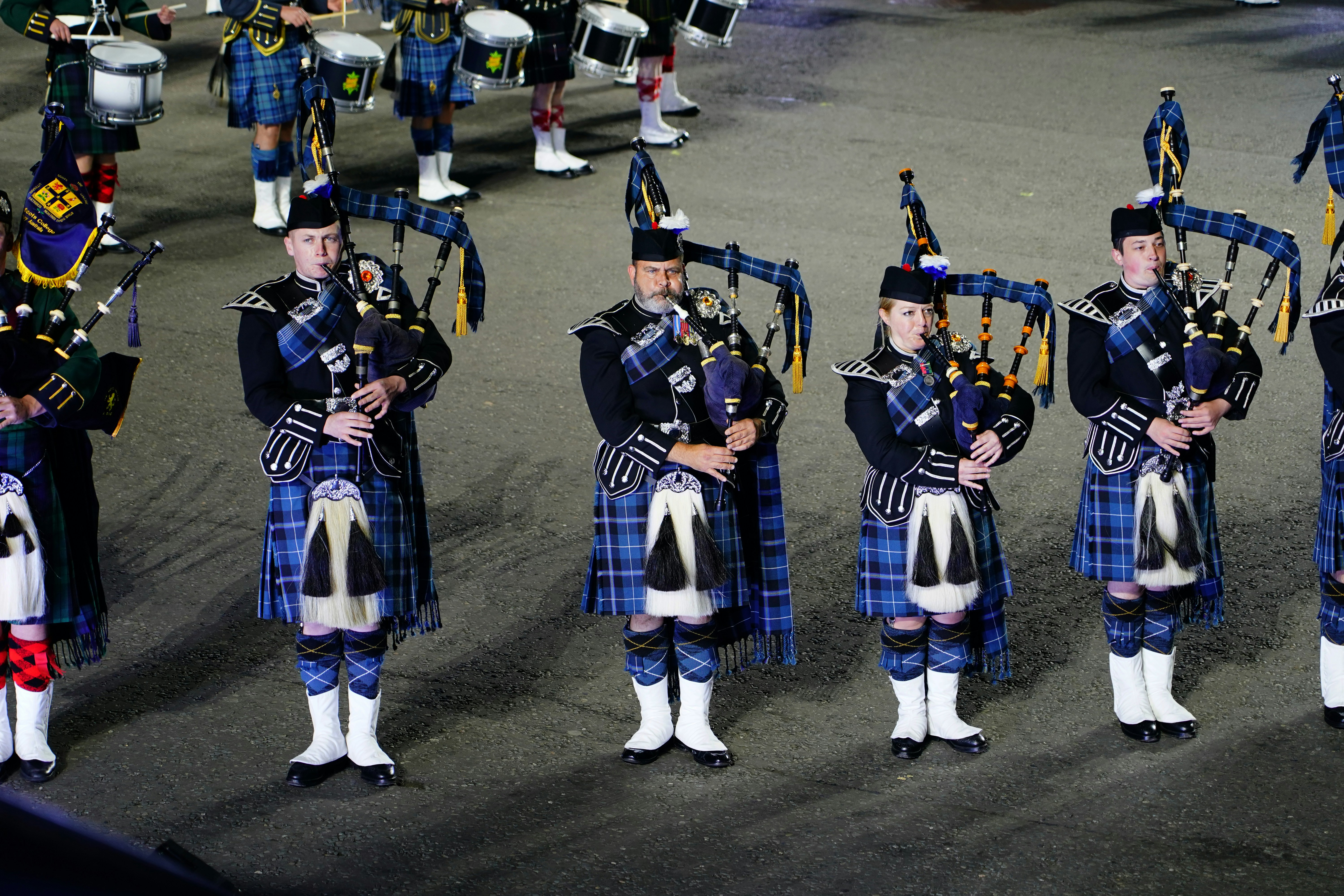 a group of men in kilts standing next to each other