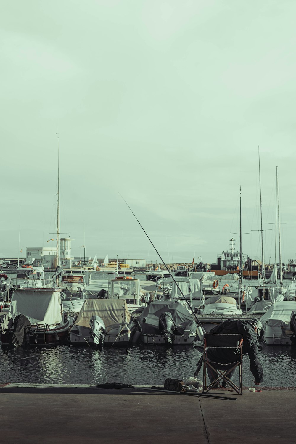 a harbor filled with lots of boats on a cloudy day