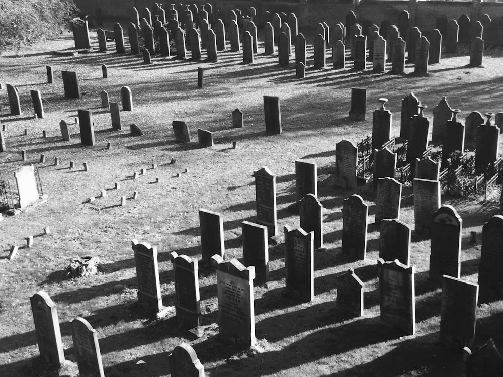 a cemetery with many headstones in the grass