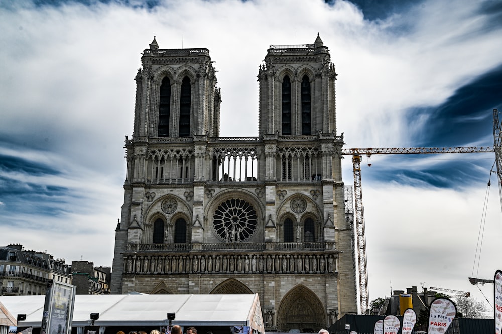 a group of people standing in front of a large cathedral