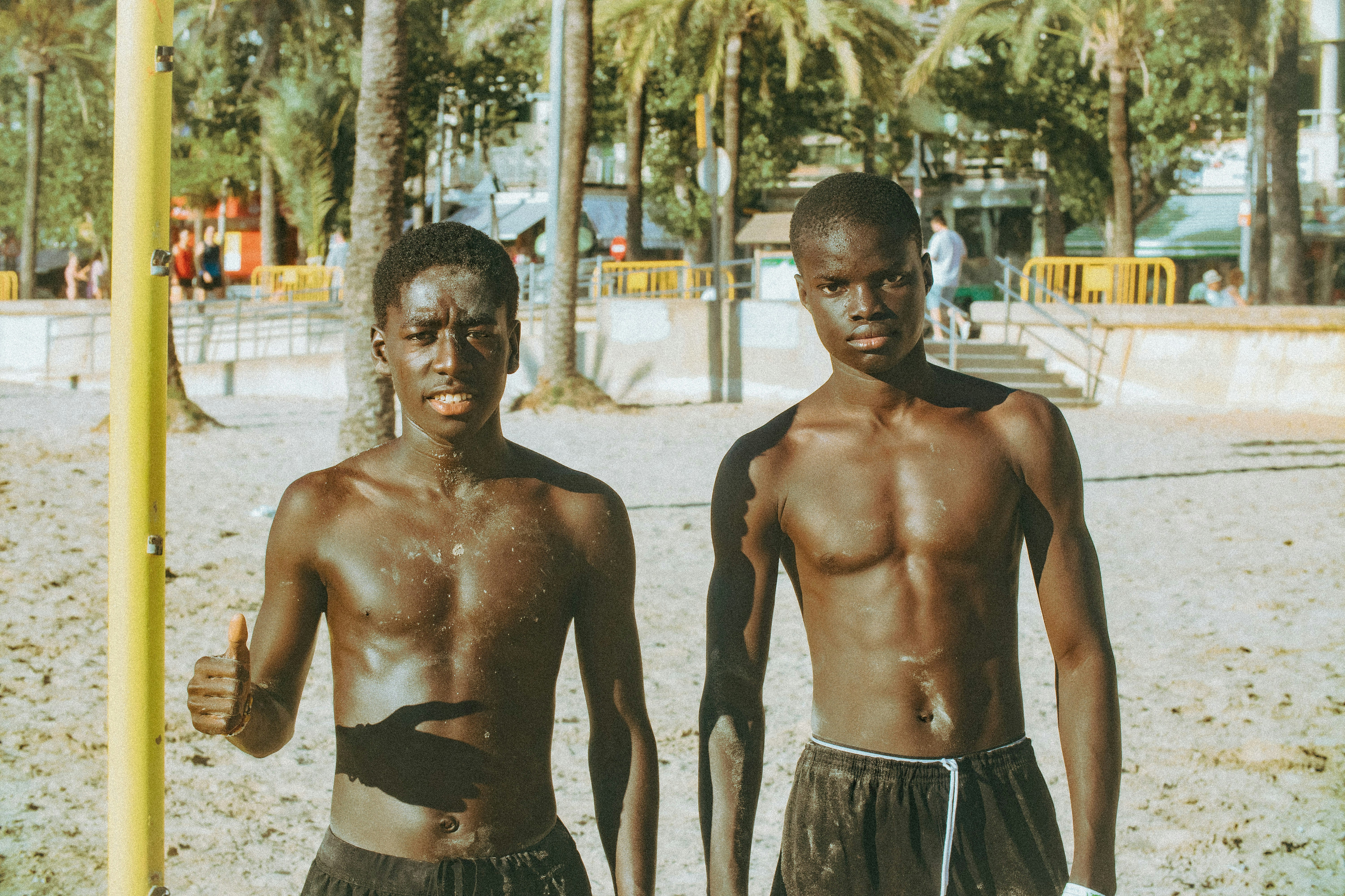Deux jeunes hommes discutant debout sur une plage des Bahamas