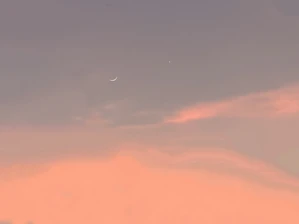 soft stars twinkling over a dimly lit room with a crescent moon glowing gently outside the window.