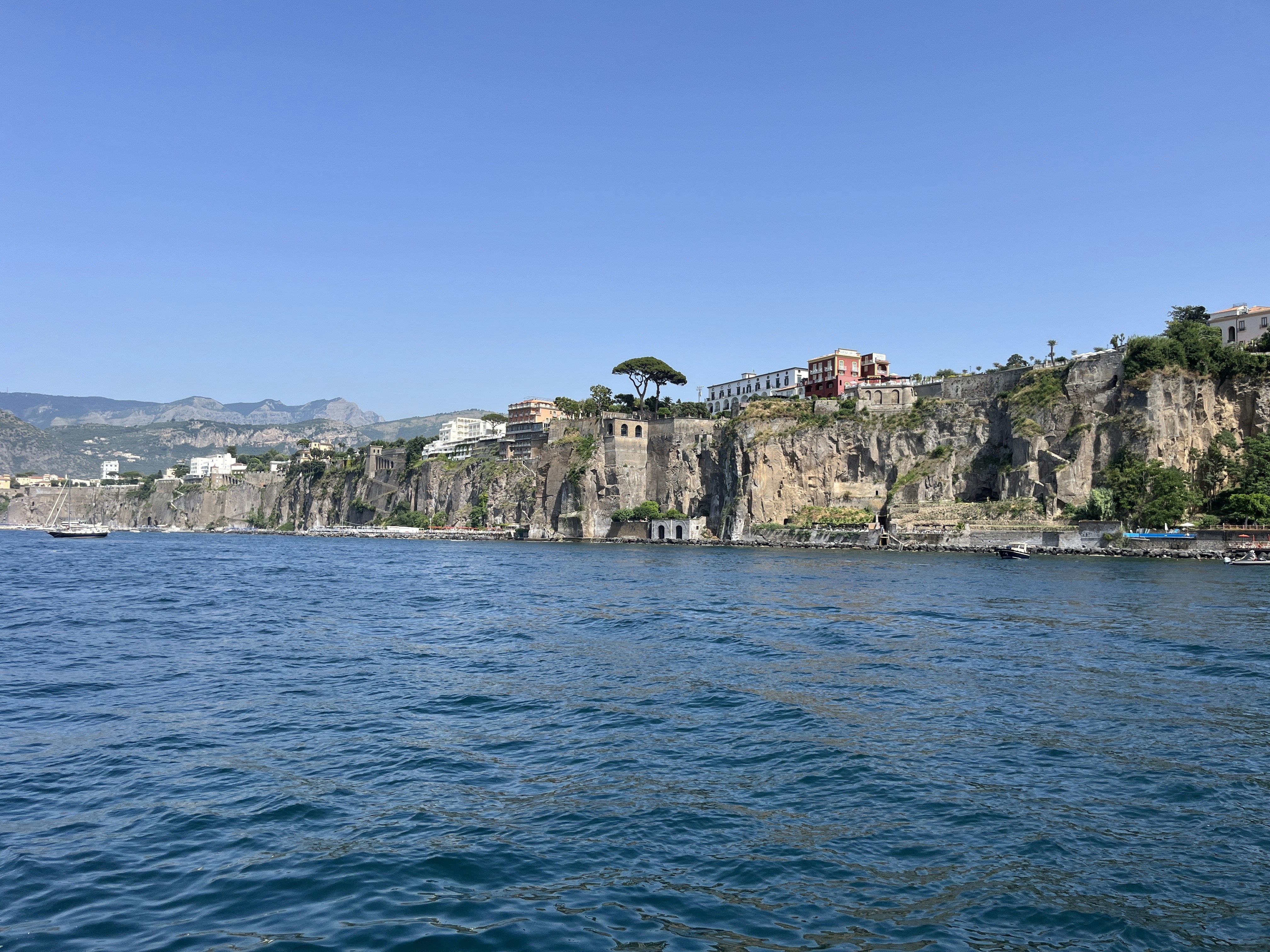 a large body of water next to a cliff