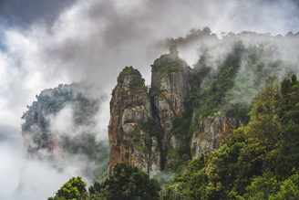a mountain covered in fog and clouds
