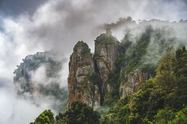 a mountain covered in fog and clouds