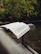 An open book on a park bench surrounded by nature.