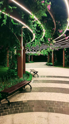 Serene garden path lined with flowering plants and benches.