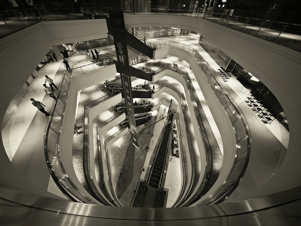 a black and white photo of an escalator at night