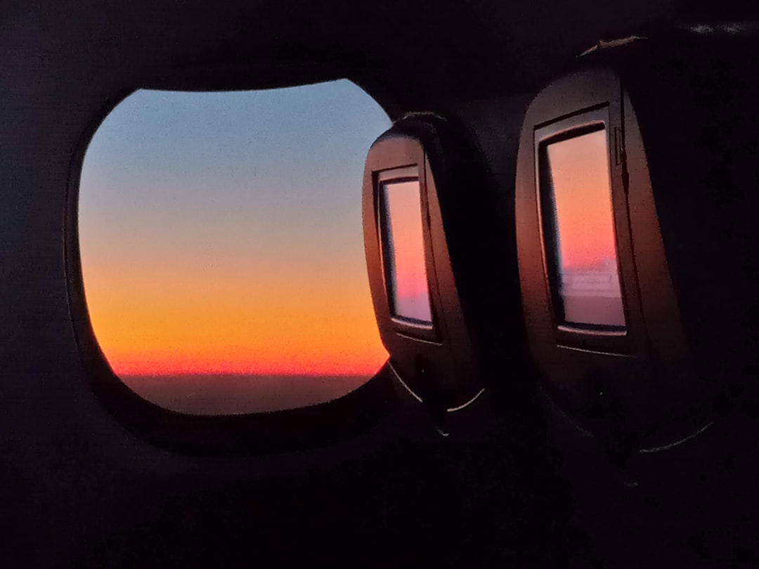 the view out of an airplane window at sunset, Sunrise onboard an airplane.